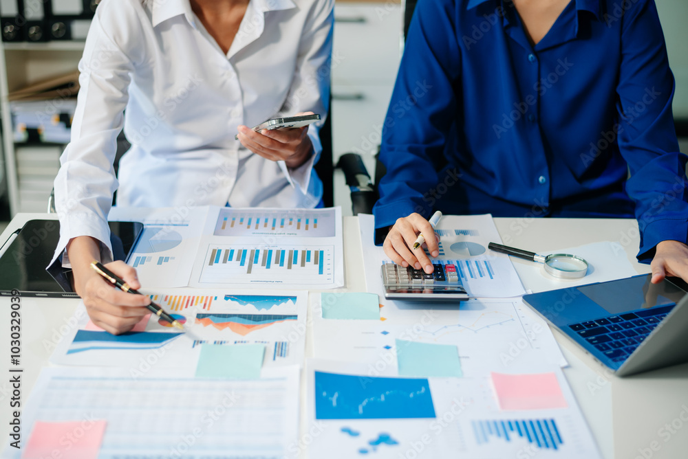 Poster business documents on office table with smart phone and calculator digital tablet and graph business