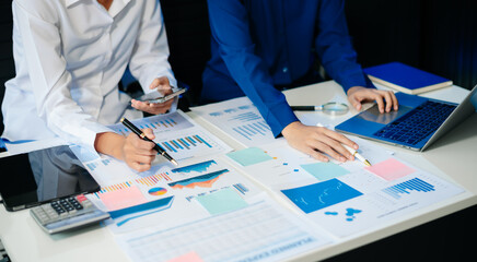 Business documents on office table with smart phone and calculator digital tablet and graph business with social network diagram