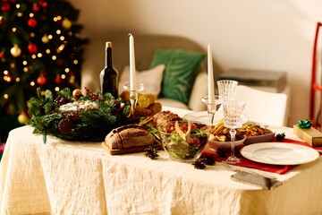Delicious festive food on table, wine and bread.