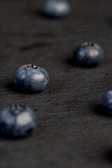 blueberries scattered on a black slate board
