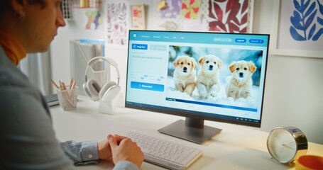 Young man enters prompt in AI image generator on PC. Artificial intelligence software generates detailed photo of puppies. From text prompt to realistic generated image. Futuristic automated artwork.