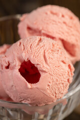 red strawberry-flavored ice cream in a glass bowl