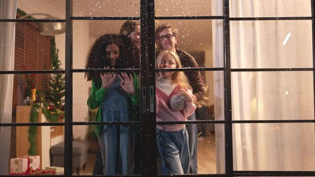 Parents and a teen girl on Christmas night with the first snowfall
