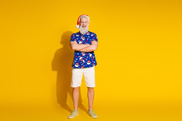 Full size photo of stylish modern santa crossed arms empty space wear x-mas winter print shirt isolated on yellow color background