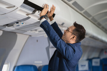 Successful business man, Airplane, travel, enjoying comfortable flight while sitting in the airplane cabin.