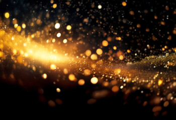 Obraz premium Abstract background with a blurred golden bokeh effect against a dark backdrop.