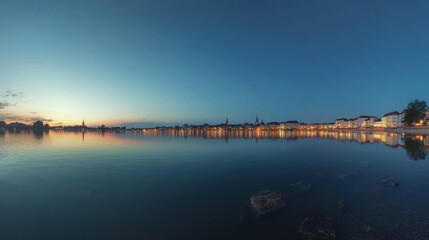 Obraz premium Cityscape Reflected in Tranquil Water at Dusk