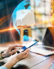 Close-up photo of female hands with smartphone. Concept of networking or remote work. Global business network.