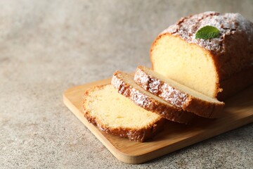 Freshly baked sponge cake on light grey table, closeup