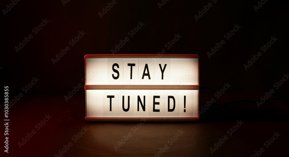 Aufkleber light box with stay tuned message illuminated in dark setting for modern decor