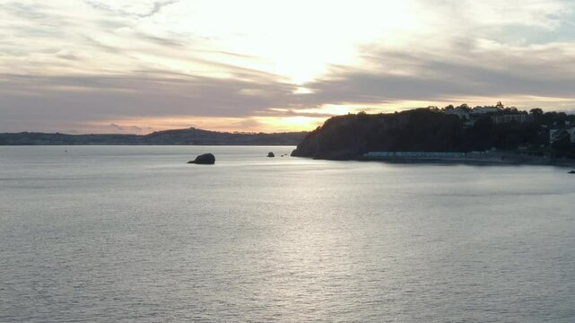 sunset over the sea Torquay Devon drone footage tracking left panning slightly right