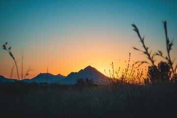 Photo of behind a mountain sunset sky landscape.