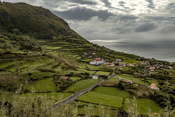 Naklejka premium Small village with stone houses anf a white church in Flores island Azores Portugal