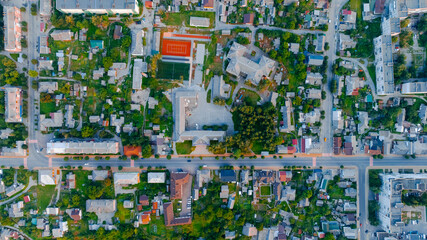 aerial drone city scape above foreshortening green town landmark Europe living district streets