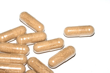 Vitamin Capsules and Pills on a White Background For Medication round and long shaped