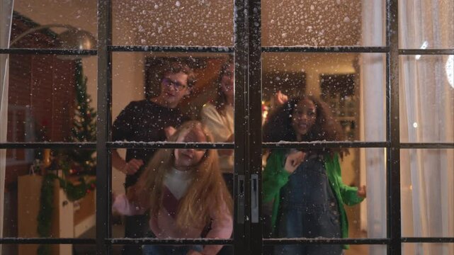 Parents and a teen girl on Christmas night with the first snowfall