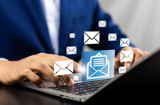 New email notification alerts concept for Digital marketing business communication through virtual inbox and internet technology as Business people use laptop with emails on a virtual screen