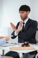 Confident businesswoman sitting at desk reviewing legal documents and contracts to ensure fairness and balanced decisions in legal and criminal matters.