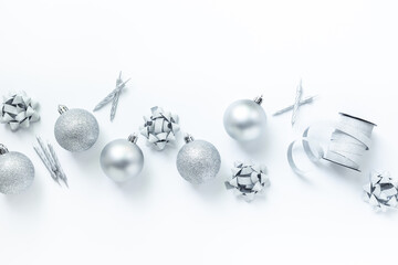 Silver colored Christmas and New Year decorations on white background, top view