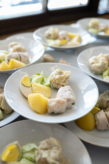 Siomay with hard boiled egg, potato and cabbage on a white plate
