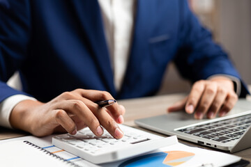 Business finance and budget management, Businessman using calculator and analyzing invoices and tax...