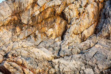 Brown colored Basalt sheer rocks  cuted by cracks due geology and by constant wind and temperature fluctuations. This cliff  is riddled with caves  