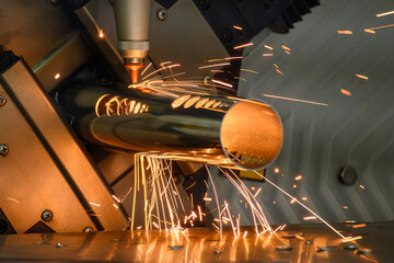 Close up scene the fiber laser cutting machine cut the stainless steel tube and sparkling light.