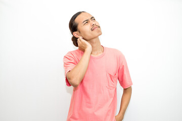 Asian, Indonesian man with long hair and bored face, sleepy and yawning standing wearing pink shirt. isolated on white background