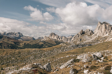 Dolomite mountain range seen from a rocky high altitude plateau, with dramatic clouds overhead