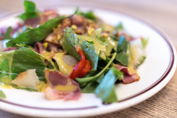 salad of fresh vegetables, greens and beef with sauce