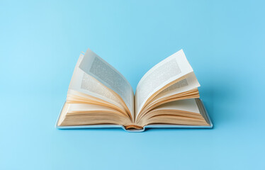 A book with the title "The Art of Writing" is open to a page with a blue background. The book is a collection of writing tips and techniques