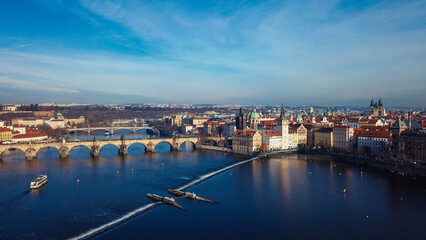 Naklejka premium A panoramic view of the Vltava River and historic architecture in Prague during a clear day