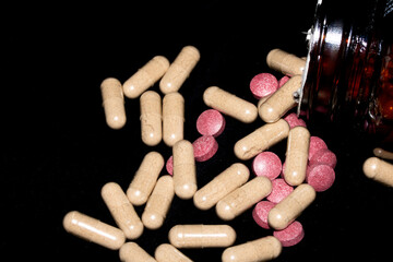 Vitamin Capsules and Pills on a White Background For Medication round and long shaped