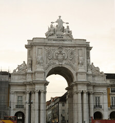 Rua Augusta Arch Monument in Lisbon, Portugal, Captured from Low Angle Under Cloudy Sky