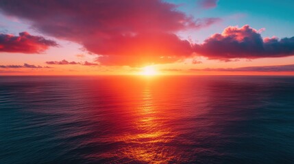 Fototapeta premium Aerial view of Epic Sunset over the Ocean and Sky with Clouds on the Horizon 