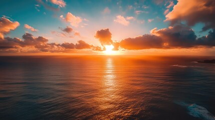 Fototapeta premium Aerial view of Epic Sunset over the Ocean and Sky with Clouds on the Horizon 
