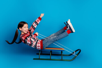 Photo of funky crazy cheerful girl dressed red clothes enjoy christmas amusement isolated on blue...