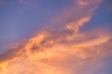 A beautiful sky tinted by the sun leaving vibrant shades of gold, pink, blue and multicolored. Clouds in the twilight evening and morning sky. Cloudy sky background in the evening, and during the day.