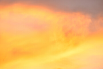 A beautiful sky tinted by the sun leaving vibrant shades of gold, pink, blue and multicolored. Clouds in the twilight evening and morning sky. Cloudy sky background in the evening, and during the day.