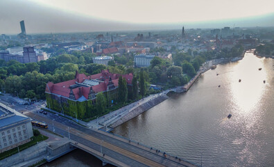 National Museum in Wroclaw and Vistula river and small boats and sun shining in water