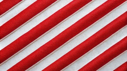 Fototapeta premium Holiday background of red and white diagonal stripes material, extreme close-up