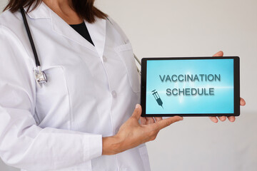 Vaccination schedule. woman doctor with stethoscope and message on a tablet