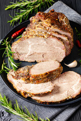 Roast Pork Neck sliced on a plate, top view