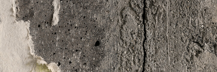 Torn old faded paper wallpaper on a concrete wall. Ragged scraps of white paper on a gray background. Vintage texture for background and design. Closeup view with copy space for text.