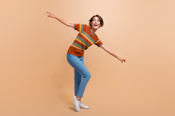 Full length photo of satisfied overjoyed person enjoy dancing partying free time isolated on beige color background