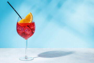 A cocktail arranged on a table against a light blue background