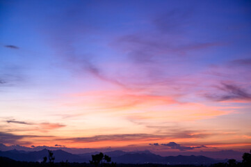 Evening time of panorama mountain under dramatic twilight sky and cloud. Nightfall Silhouette mountain on sunset.