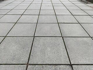 A concrete patio with a bench in the middle of it