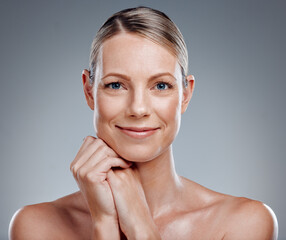 Beauty, portrait and smile of mature woman in studio on gray background for facial cosmetics. Half...