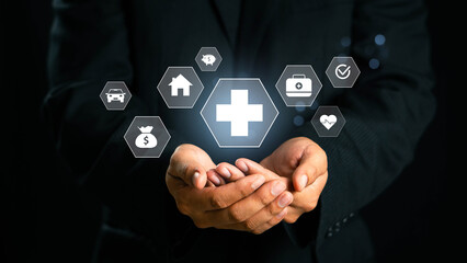 Businessman hand holding virtual medical health care icons with medical network connection. Healthcare insurance concept, health and access to health care, health insurance.life insurance business.